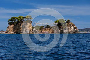 Sunny summer view of the Cameo Island. Picturesque morning scene in the Port Sostis, Zakynthos Zante island, Greece, Europe.