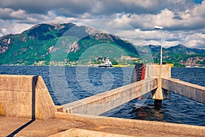 Sunny summer view of the Norwegian farry crossing through the fjord.