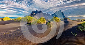 Sunny summer view of Stokksnes cape with Vestrahorn Batman Mountain on background.