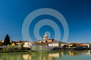 Sunny view of Church San Frediano in Cestello and river Arno
