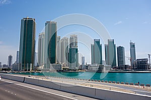 Sunny view of Dubai`s skyline with multiple skyscrapers