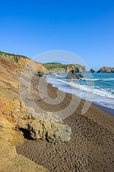 Sunny view on empty wild Rodeo Beach in California