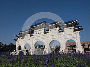 Sunny view of the Liberty Square Arch with many flower blossom