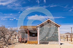 Sunny view of the Tom Kellys Bottle House