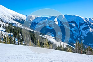 Sunny Weather Over Empty Ski Slope and Mountain Relief