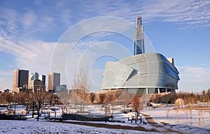 Sunny winter day sunset in Winnipeg downtown. Winter view on Canadian Museum for Human Rights in foreground and high