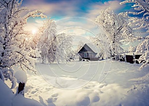 Sunny winter morning in the mountain village after heavy snowfall.