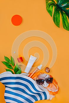 Sunscreen.. Beach set: hat, sun glasses and protection cream SPF Beach accessories. Summer Travel Vacation Concept photo