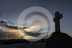 Sunrays in background of a cross