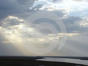 Sunrays through Clouds spreading over a River