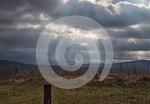 Sunrays over a smoky mountain valley