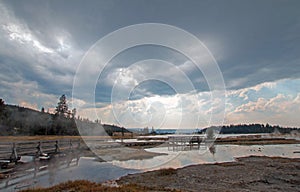 Sunrays and sunbeams above steam rising off Hot Lake in the Lower Geyser Basin in Yellowstone National Park in Wyoming USA