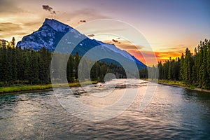 Sunrise above Bow River and Mount Rundle from Banff Pedestrian Bridge in Canada