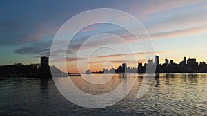 Sunrise above Manhattan, New York, NY - View across Hudson River from Pier A Park in Hoboken, NJ.