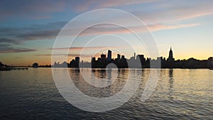 Sunrise above Manhattan, New York, NY - View across Hudson River from Pier A Park in Hoboken, NJ.