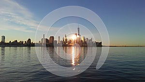 Sunrise above Manhattan, New York, NY - View across Hudson River from Pier A Park in Hoboken, NJ.