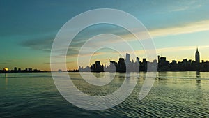 Sunrise above Manhattan, New York, NY - View across Hudson River from Pier A Park in Hoboken, NJ.