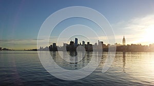 Sunrise above Manhattan, New York, NY - View across Hudson River from Pier A Park in Hoboken, NJ.