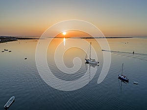 Sunrise aerial seascape view of Olhao dockyard, waterfront to Ria Formosa natural park with Armona island in background