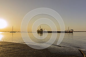 Sunrise aerial seascape view of Olhao dockyard, waterfront to Ria Formosa natural park with Armona island in background photo