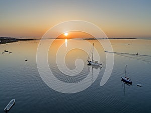 Sunrise aerial seascape view of Olhao dockyard, waterfront to Ria Formosa natural park with Armona island in background photo