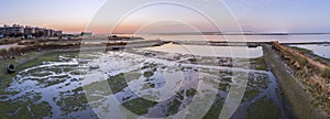 Sunrise aerial seascape view of Olhao salt marsh Inlet, waterfront to Ria Formosa natural park. Algarve.