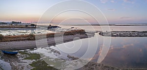 Sunrise aerial seascape view of Olhao salt marsh Inlet, waterfront to Ria Formosa natural park. Algarve.