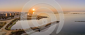 Sunrise aerial seascape view of Olhao salt marsh Inlet, waterfront to Ria Formosa natural park. Algarve.