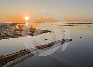 Sunrise aerial seascape view of Olhao salt marsh Inlet, waterfront to Ria Formosa natural park. Algarve.
