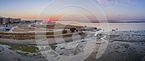 Sunrise aerial seascape view of Olhao salt marsh Inlet, waterfront to Ria Formosa natural park. Algarve.