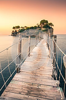 The sunrise at Agios Sostis Island, Cameo Island in Zakynthos, Greece. Wooden bridge.
