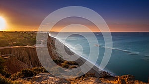 Sunrise at Algarve beach cliffs Portugal