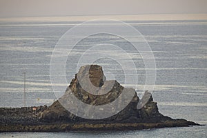 Sunrise on the beach. Beach with large stones and rocks. Ocean stones at the beach. Concept of calm, meditation, serenity.