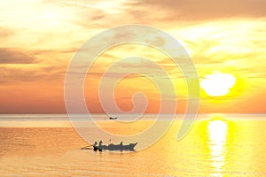 Sunrise on the beach with fishing boat in the morning