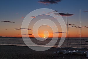 Sunrise on the beach with two catamarans stranded on the shore in Mojacar Almeria