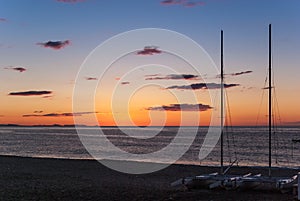 Sunrise on the beach with two catamarans stranded on the shore in Mojacar Almeria