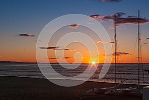 Sunrise on the beach with two catamarans stranded on the shore in Mojacar Almeria