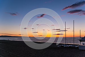 Sunrise on the beach with two catamarans stranded on the shore in Mojacar Almeria