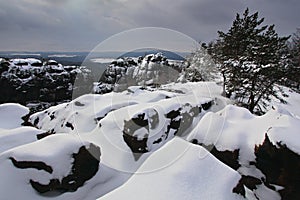 Before Sunrise in a beautiful mountain landscape of Czech-Saxony Switzerland. Winter in the Czech landscape. Snow in the rock.