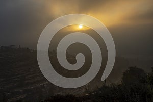 A Sunrise behind Clouds and Fog over Jerusalem, Israel