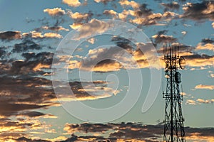 Sunrise behind a communications tower for radio and tv broadcasting