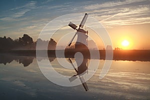 Sunrise behind Dutch windmill