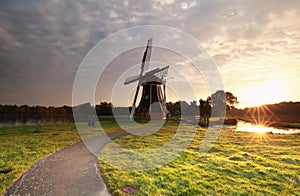 Sunrise behind Dutch windmill