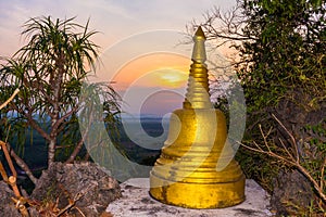 Sunrise behind the golden stupa on high mountain