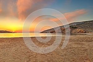 The sunrise behind in Livadi beach of Folegandros island, Greece