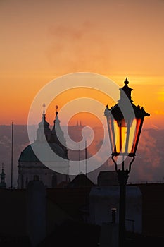 Sunrise behind an old street lamp over Lesser Town, Prague, Czech Republic