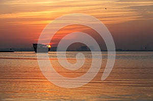 Sunrise behind the traditional fishing Dhow