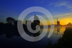 Sunrise behind a windmill