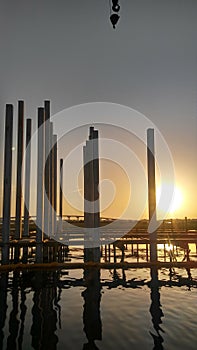 Sunrise berween pilings bridge background