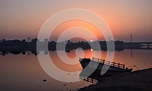 Sunrise with boat on yamuna river